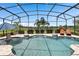 Relaxing screened-in pool area overlooking a golf course with lounge chairs and a clear blue sky at 1212 Zeek Ridge St, Clermont, FL 34715