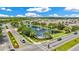 Beautiful aerial view of the community featuring a pond with fountain, lush landscaping, and well-maintained streets at 12216 Prairie Plantation Way, Orlando, FL 32824