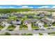 Expansive aerial shot of a vibrant community with well-manicured lawns, diverse home styles, and tree-lined streets at 12216 Prairie Plantation Way, Orlando, FL 32824