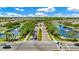 Aerial view of community entrance with fountains, landscaping, and residential homes at 12216 Prairie Plantation Way, Orlando, FL 32824