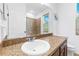 Bathroom vanity featuring granite countertops, white sink, and tiled shower stall at 12216 Prairie Plantation Way, Orlando, FL 32824