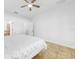 Bedroom featuring tiled floor, ceiling fan, and a door leading to the en suite bath at 12216 Prairie Plantation Way, Orlando, FL 32824