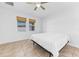 Bedroom featuring tile floors, ceiling fan and two windows with natural light at 12216 Prairie Plantation Way, Orlando, FL 32824