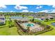 Aerial view of community pool, clubhouse, seating areas, and lush landscaping at 12216 Prairie Plantation Way, Orlando, FL 32824