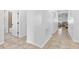 Hallway with tiled floor leading to a bathroom and living room at 12216 Prairie Plantation Way, Orlando, FL 32824