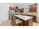Modern kitchen features stainless steel appliances, rich wood cabinets, and a spacious island with seating at 12216 Prairie Plantation Way, Orlando, FL 32824