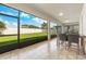 Covered screened patio with a dining area and views of the spacious backyard at 12216 Prairie Plantation Way, Orlando, FL 32824