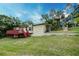 Backyard view featuring a raised deck with steps and well-maintained landscaping at 1335 E 3Rd Ave, Mount Dora, FL 32757