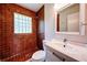 Bathroom featuring red tiled shower and floor, vanity and window at 1335 E 3Rd Ave, Mount Dora, FL 32757