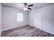 Bedroom with new flooring, a ceiling fan and window at 1335 E 3Rd Ave, Mount Dora, FL 32757
