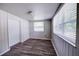 Bedroom with new flooring, fresh paint and a large window at 1335 E 3Rd Ave, Mount Dora, FL 32757