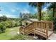 Charming home with wooden stairway, lush landscaping, and mature trees at 1335 E 3Rd Ave, Mount Dora, FL 32757