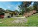 A charming home exterior with wooden stairs and mature trees at 1335 E 3Rd Ave, Mount Dora, FL 32757