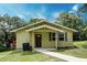 Charming single-story home featuring a cozy front porch and well-maintained lawn at 1335 E 3Rd Ave, Mount Dora, FL 32757