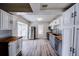 Open kitchen layout featuring white cabinets, stainless steel appliances, and wood countertops at 1335 E 3Rd Ave, Mount Dora, FL 32757