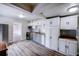 Bright kitchen with stainless steel appliances, white cabinets, and ample countertop space at 1335 E 3Rd Ave, Mount Dora, FL 32757