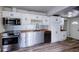 Modern kitchen with white cabinets, stainless steel appliances, and butcher block countertops at 1335 E 3Rd Ave, Mount Dora, FL 32757