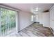 Bright living room with wood-look flooring and sliding glass doors at 1335 E 3Rd Ave, Mount Dora, FL 32757