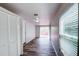 Bright living room boasts wood floors, closet, and sliding door to outdoor deck at 1335 E 3Rd Ave, Mount Dora, FL 32757