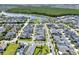 An aerial view shows a neighborhood with a lake, green spaces and rows of houses and well-kept lawns at 14366 Walcott Ave, Orlando, FL 32827