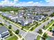 An aerial view shows a neighborhood with rows of houses and well-kept lawns and many other homes nearby at 14366 Walcott Ave, Orlando, FL 32827