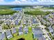 An aerial view shows a neighborhood with a lake, green spaces and rows of houses and well-kept lawns at 14366 Walcott Ave, Orlando, FL 32827