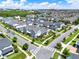 An aerial view shows a neighborhood with rows of houses and well-kept lawns and many other homes nearby at 14366 Walcott Ave, Orlando, FL 32827