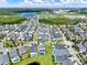 An aerial view shows a neighborhood with a lake, green spaces and rows of houses and well-kept lawns at 14366 Walcott Ave, Orlando, FL 32827