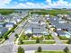 An aerial view shows a neighborhood with a lake, green spaces and rows of houses and well-kept lawns at 14366 Walcott Ave, Orlando, FL 32827
