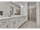 Modern bathroom with double sink vanity, quartz countertops, large mirror, walk-in shower, and wood-look tile flooring at 14366 Walcott Ave, Orlando, FL 32827