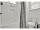 Bright bathroom with a shower-tub combo featuring white subway tile surround with a built-in niche at 14366 Walcott Ave, Orlando, FL 32827