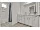 Bathroom vanity features a white countertop, cabinets, and grey tile floors at 14366 Walcott Ave, Orlando, FL 32827