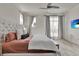 Bright bedroom featuring a plush bed, ceiling fan, and a wall-mounted TV for ultimate comfort at 14366 Walcott Ave, Orlando, FL 32827