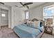Cozy bedroom with carpet flooring, a ceiling fan, and ample natural light from the windows at 14366 Walcott Ave, Orlando, FL 32827