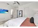 Spacious bedroom with a ceiling fan, a TV for entertainment, and a view into the ensuite bathroom at 14366 Walcott Ave, Orlando, FL 32827