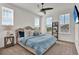 Light-filled bedroom with three large windows, ceiling fan and neutral carpet at 14366 Walcott Ave, Orlando, FL 32827