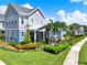 Charming two-story home showcasing manicured landscaping, lush green lawns, and a welcoming outdoor living space at 14366 Walcott Ave, Orlando, FL 32827
