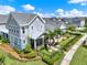 Attractive two-story home featuring a landscaped yard, black fence, screened porch, and inviting outdoor patio at 14366 Walcott Ave, Orlando, FL 32827