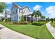 Charming two-story home showcasing a lush lawn, beautiful landscaping, and welcoming screened porch at 14366 Walcott Ave, Orlando, FL 32827