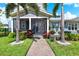 Charming home with a screened-in porch, lush landscaping, and a brick walkway leading to the entrance at 14366 Walcott Ave, Orlando, FL 32827