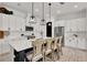 Elegant kitchen with white cabinets, stainless steel appliances, a black island, and modern pendant lights at 14366 Walcott Ave, Orlando, FL 32827