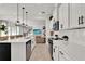Open concept kitchen with an island, stainless appliances, tile backsplash and wood floors at 14366 Walcott Ave, Orlando, FL 32827