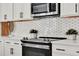 A modern kitchen featuring stainless steel appliances, stylish countertops, and white cabinets at 14366 Walcott Ave, Orlando, FL 32827