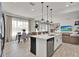 Spacious kitchen with a center island, stainless steel appliances, and a dining area near a large window at 14366 Walcott Ave, Orlando, FL 32827