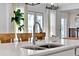 Modern kitchen sink with chrome faucet and white countertops, complemented by bright, natural lighting at 14366 Walcott Ave, Orlando, FL 32827