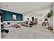 Spacious living room featuring tile floors, a modern accent wall, and an open-concept design connected to the kitchen at 14366 Walcott Ave, Orlando, FL 32827