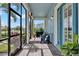 Inviting screened porch with brick flooring, comfortable seating, and views of the surrounding landscape at 14366 Walcott Ave, Orlando, FL 32827