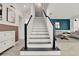 Elegant staircase with white risers, dark treads, and black handrail at 14366 Walcott Ave, Orlando, FL 32827
