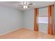 Bright bedroom with a ceiling fan, light hardwood floors, and a window with curtains at 150 Wax Myrtle Woods Ct # 3D, Deltona, FL 32725