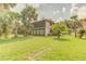 Inviting condo complex with lush lawn, tall trees, and screened patios at 150 Wax Myrtle Woods Ct # 3D, Deltona, FL 32725